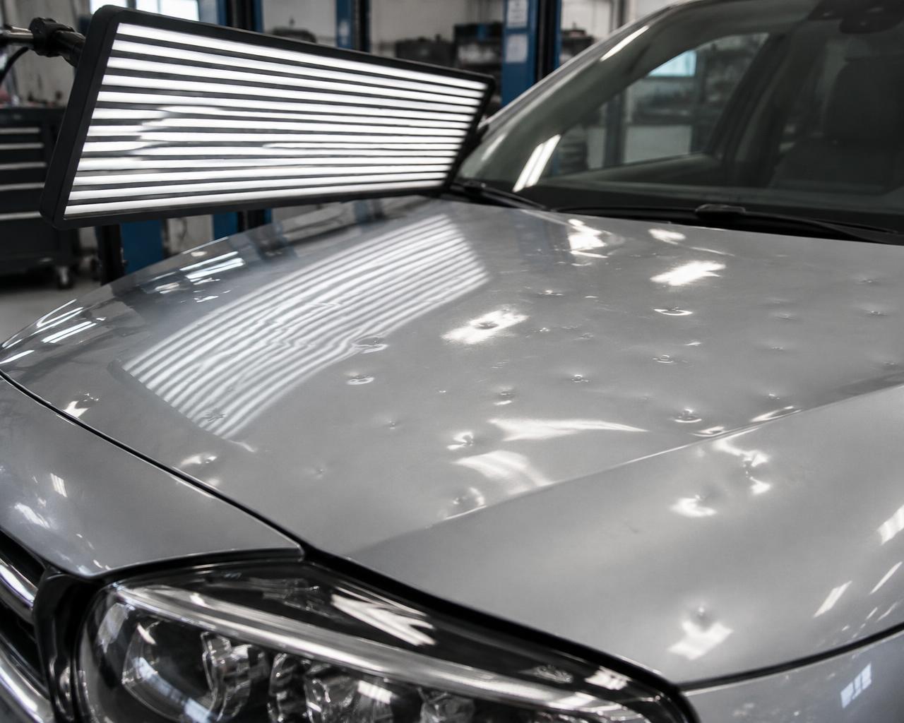 Hail damage inspected under PDR lighting